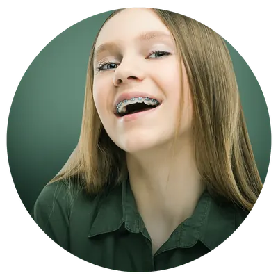Patient smiling with braces on their teeth